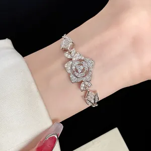 Detailed view of an elegant retro silver-tone bracelet with sparkling zircon flower charms
