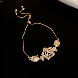 Elegant gold zircon rose and tulip charm bracelet with adjustable bolo chain.