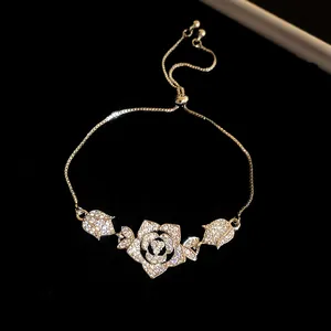 Detailed macro shot of vintage flower bracelet with sparkling zircons and adjustable gold chain