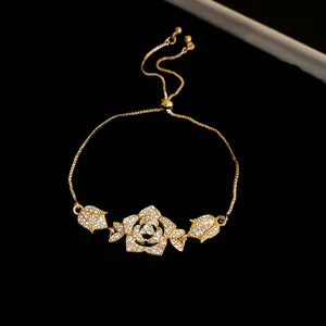 Macro view of vintage gold bracelet featuring a detailed sparkling zircon rose pendant