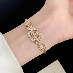 Close-up detail of a vintage-style gold rose bracelet encrusted with sparkling zircon stones