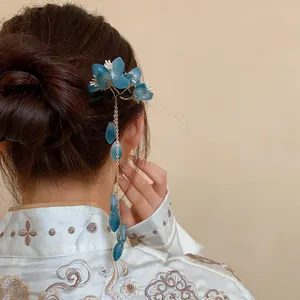 Close-up detail of a blue resin flower tassel hairpin worn by a model in Hanfu