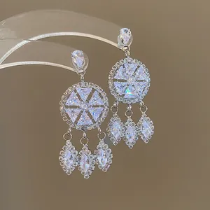 Close-up of silver-tone chandelier earrings with sparkling marquise crystal tassels.