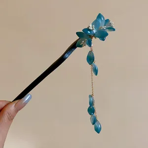 Close-up of elegant New Chinese style floral hair stick with blue hanging tassels