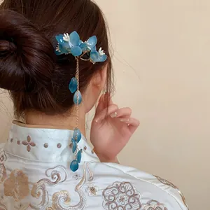 Detailed view of elegant blue floral hairpin with long dangling tassels in traditional style