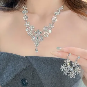 Elegant vintage silver hollow flower necklace and earring set with shimmering rhinestones