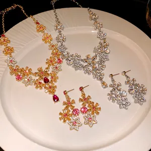 Detail of vintage hollow flower necklaces and earrings with sparkling rhinestones