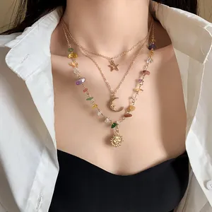 Detailed view of bohemian layered necklace with sun moon star pendants and colorful stones