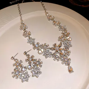 Detail view of luxury vintage floral necklace and earring set with sparkling rhinestones