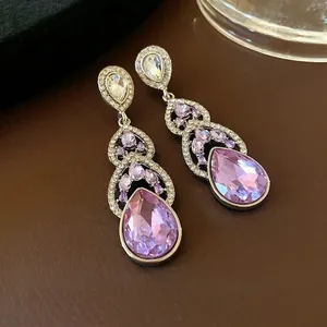 Luxurious silver needle teardrop dangle earrings with sparkling lavender crystals
