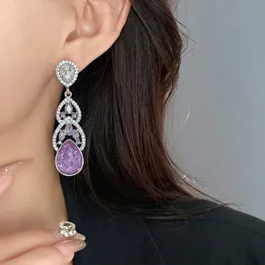 Elegant silver needle long drop earrings with purple crystals and sparkling rhinestones