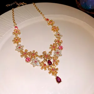 Vintage gold floral necklace with pink and yellow rhinestones and magenta teardrop pendant