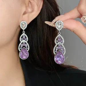 Elegant long dangle earrings with purple teardrop crystals and sparkling rhinestones