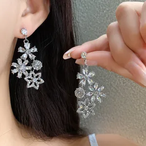 Macro view of vintage silver flower chandelier earrings with sparkling crystal rhinestones