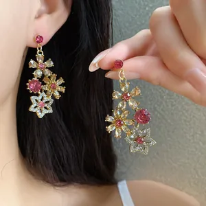 Vintage floral drop earrings with pink and champagne crystals in a hollow gold design