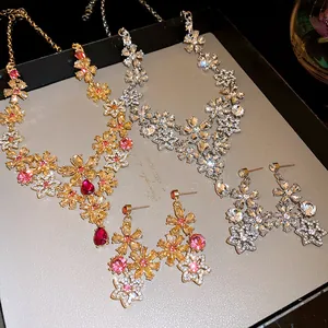 Detail of vintage hollow flower necklace and earrings with sparkling rhinestones.