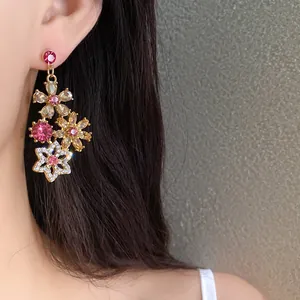 Detail of elegant vintage gold-toned floral earrings with sparkling pink and champagne rhinestones