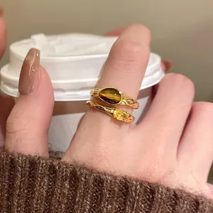 Detailed view of 18k gold plated ring with tiger eye stone and yellow zircon