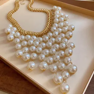 Elegant French vintage luxury gold chain necklace featuring layered pearl tassels.