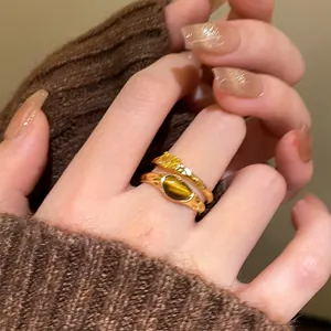 Detailed close-up showing texture of 18k gold plated tiger eye and zircon vintage rings