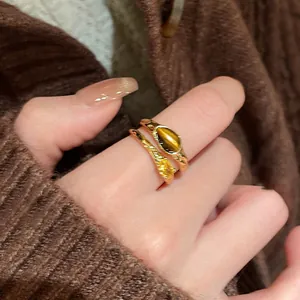 Detail shot showing the texture of vintage 18k gold plated ring with tiger eye stone and zircon.