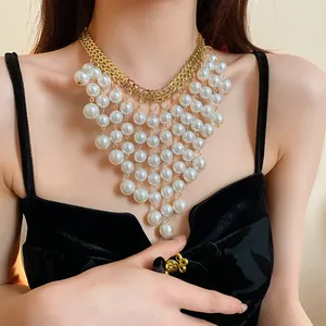 Detailed macro view of French vintage pearl tassel necklace on black velvet dress