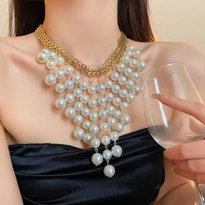 Elegant French-style multi-layered pearl fringe necklace with gold chain detail on model