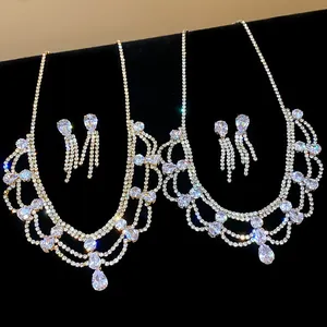 Detail view of sparkling rhinestone water drop pendant necklace and fringe earrings set.