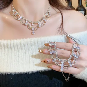 Detailed view of elegant tiered necklace with sparkling teardrop pendants on model