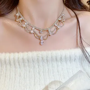 Detail view of a luxury gold-tone necklace with sparkling water-drop rhinestones
