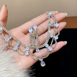 Detailed close-up of a luxury rhinestone waterdrop necklace and earring jewelry set.
