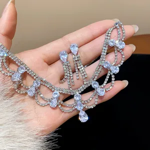 Close-up detail of silver jewelry set with teardrop sparkling rhinestones