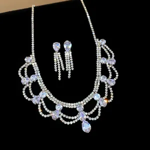 Close-up view of a luxury rhinestone teardrop jewelry set on black velvet background