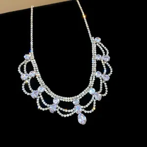 Detailed close-up of a sparkling silver teardrop pendant necklace with clear crystals