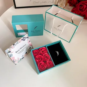 Detail of teal jewelry gift box with red soap roses and matching carrier bag