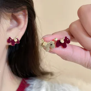 Detailed close-up showing texture of cute flocked pony earrings in burgundy and brown
