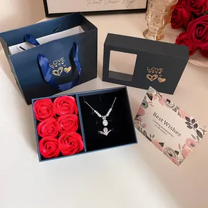Elegant jewelry gift box featuring red roses with a necklace, ring and matching gift bag