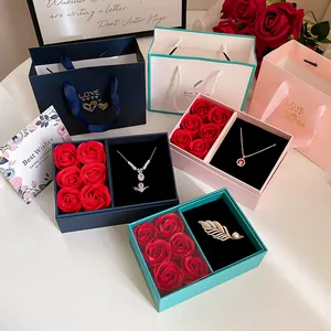Detailed view of luxury jewelry gift boxes featuring soap roses, necklaces, and brooches.