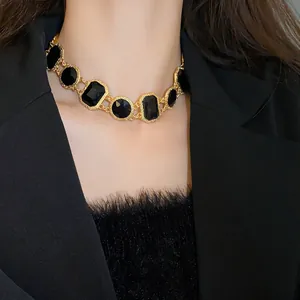 Detailed view of a vintage geometric black crystal choker necklace on an Asian model.