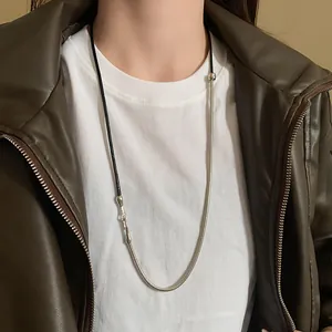 Detailed macro view of punk style mixed leather cord and silver snake chain necklace
