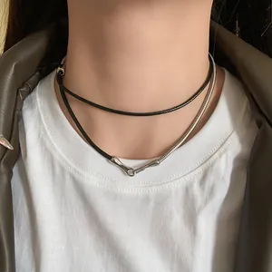 Detail shot of a punk leather cord and silver snake chain layered choker on a model.