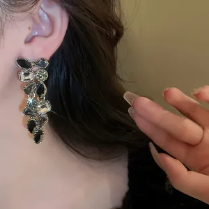 Dettaglio macro che mostra i cristalli neri e trasparenti di questi eleganti orecchini.