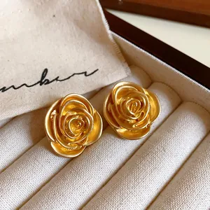 Elegant French style golden rose flower stud earrings with a vintage matte finish