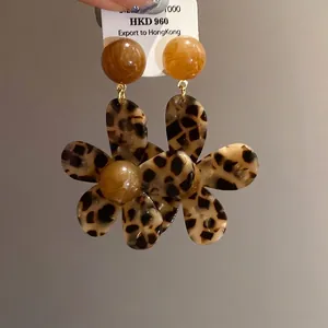 Stylish leopard print flower resin earrings with retro amber beads and silver needles.