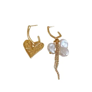 Vintage asymmetrical silver needle earrings with baroque pearls and gold heart tassel