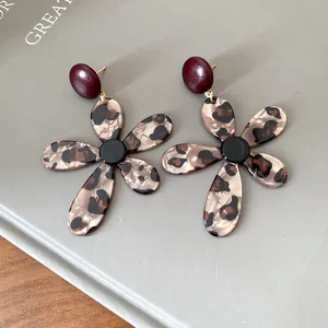 Detail showing the intricate leopard print pattern on these retro resin flower earrings