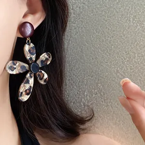 Close-up detail of stylish leopard print flower earrings crafted from retro resin material