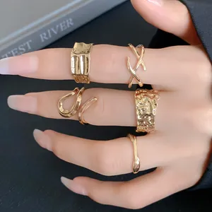 Set of five irregular gold geometric open rings worn on hand for high-end fashion