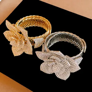 Close-up of exquisite sparkling rhinestone flower bracelets in gold and silver finishes