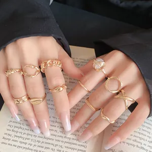 Detailed view of irregular geometric gold rings set against an open book background